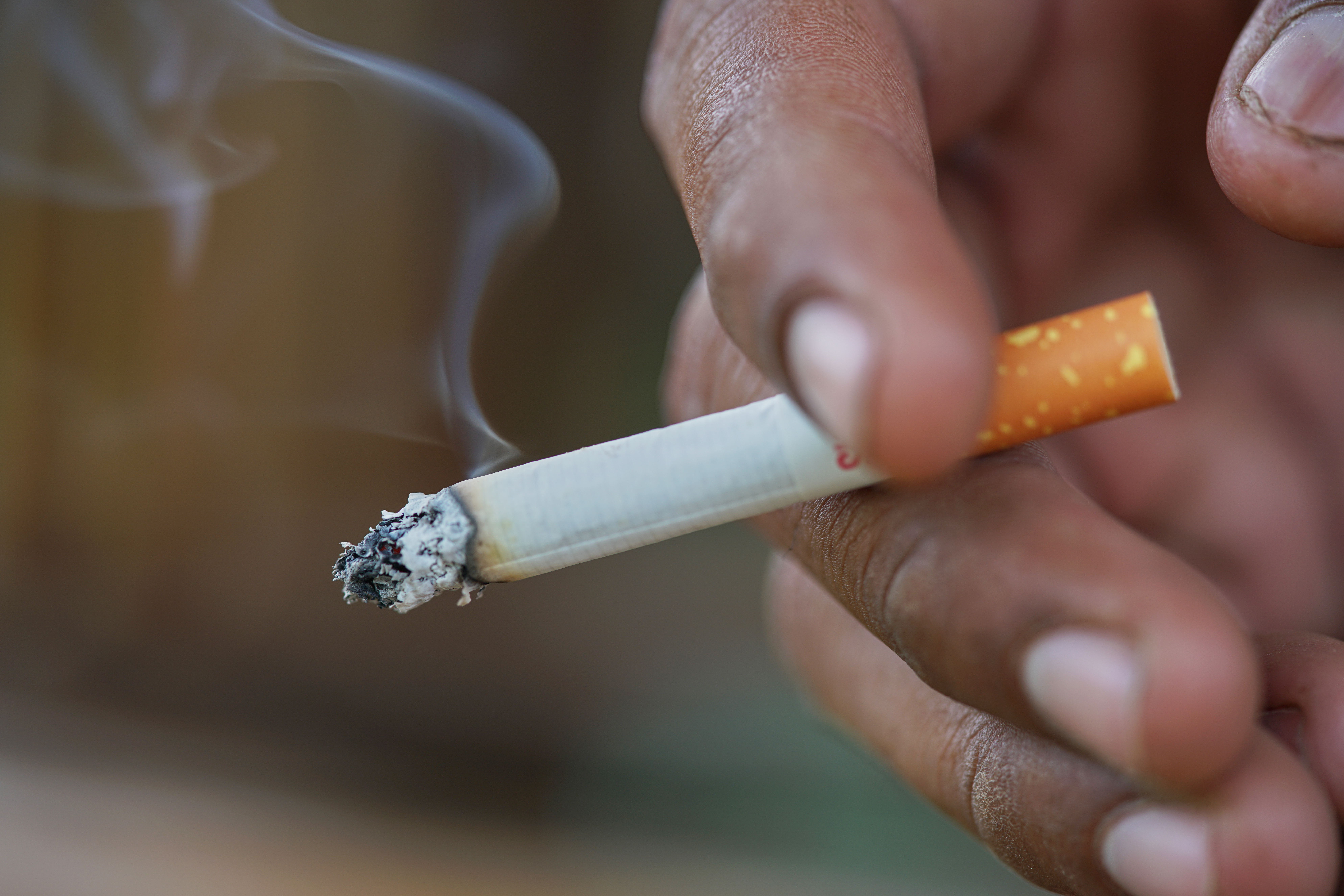a smoking cigarette in a hand